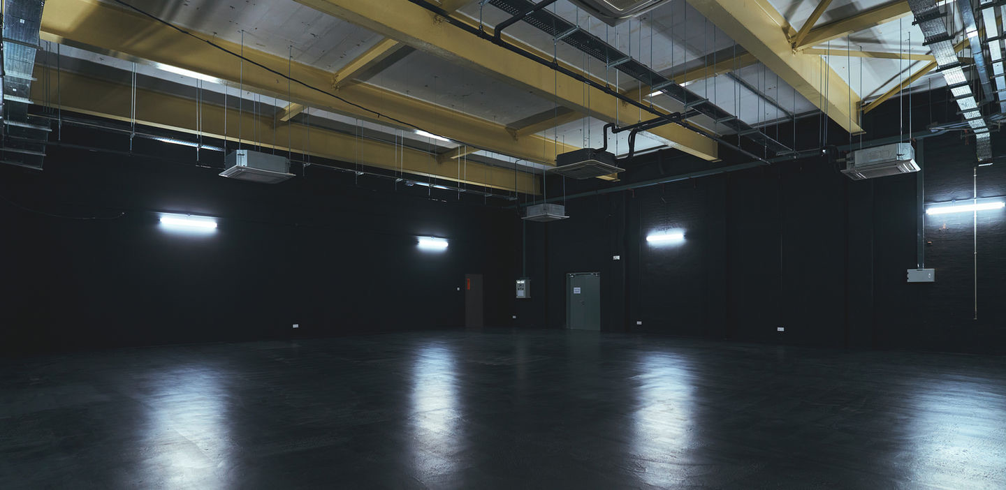Mini studio — industrial space with yellow ceiling beams and polished floor
